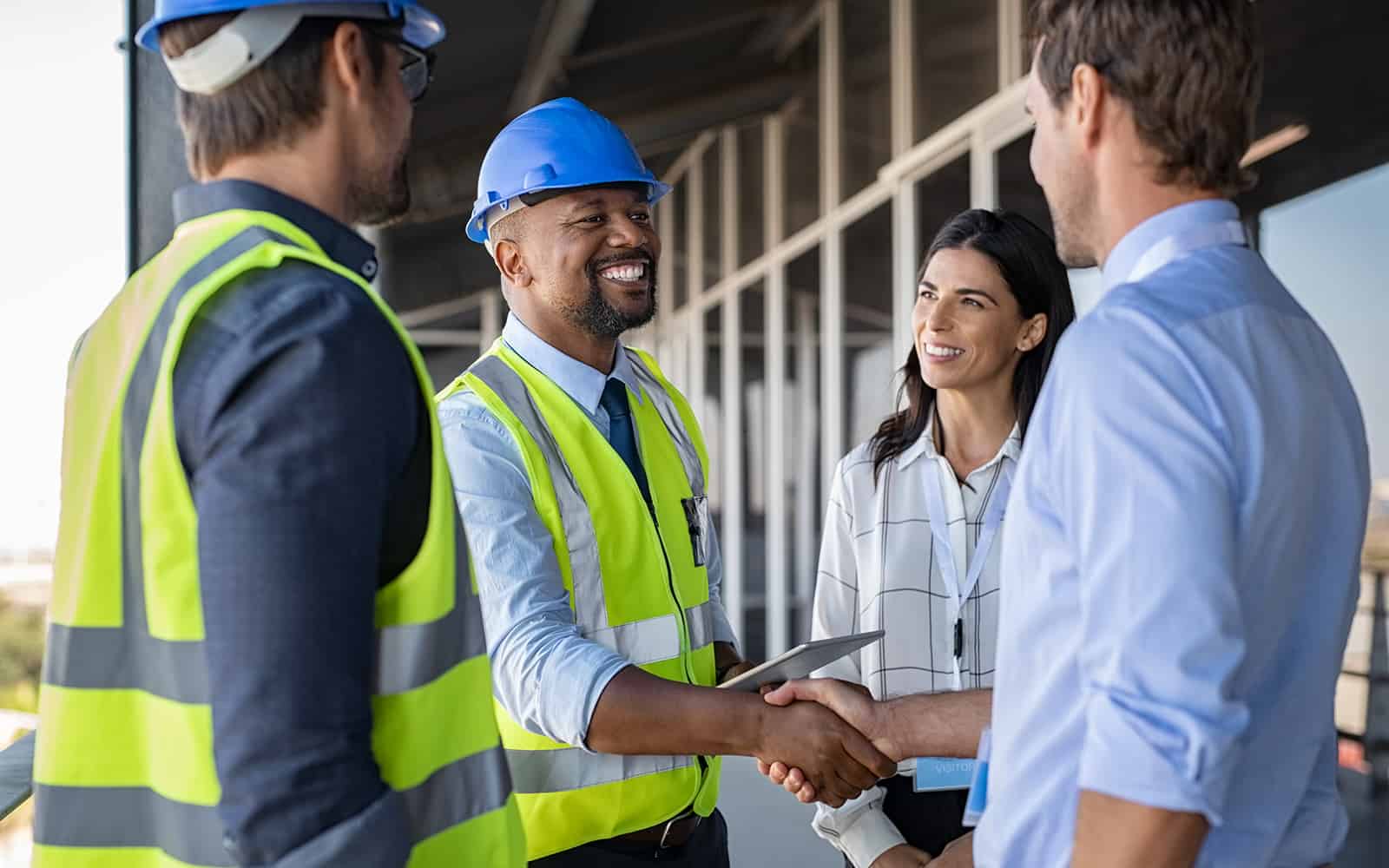 engineer and businessman handshake at construction site